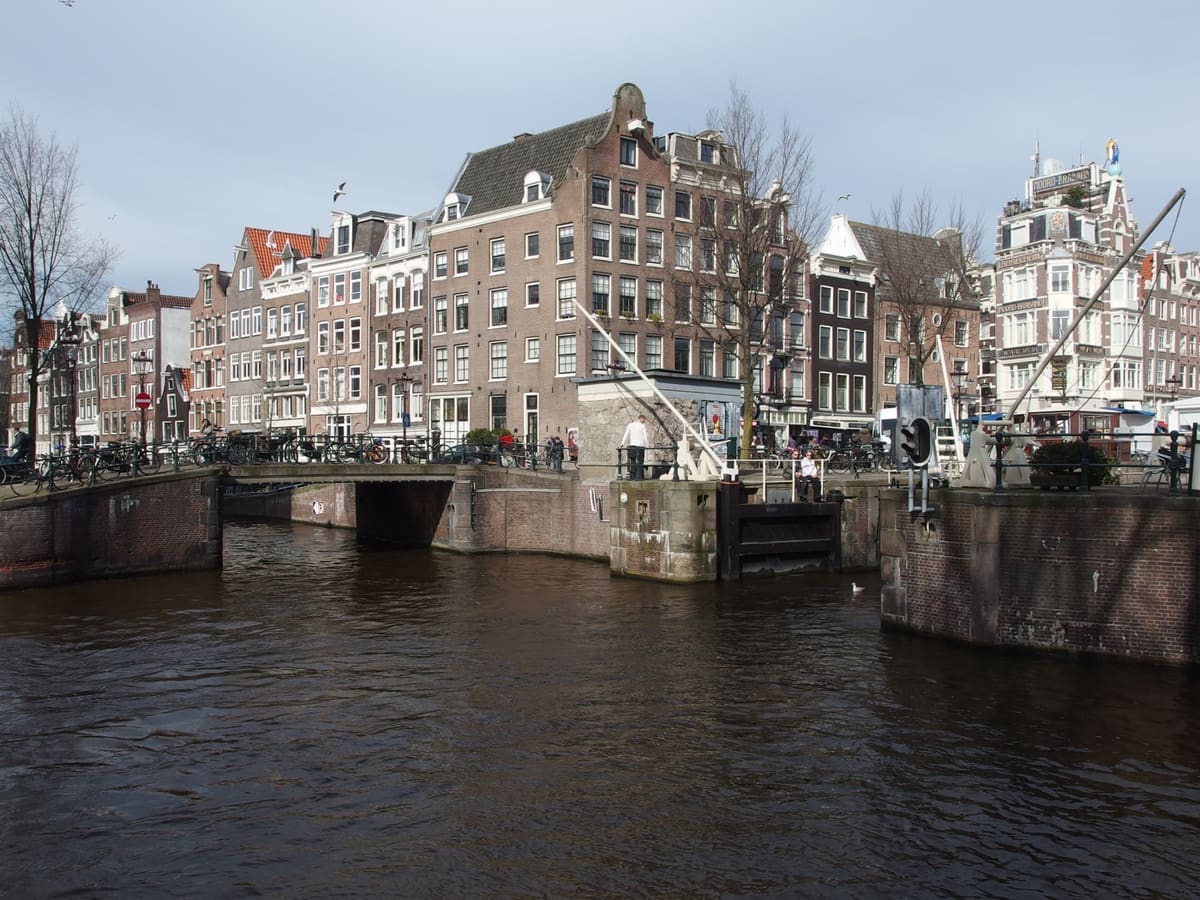 Canal boats and historic brick houses in Amsterdam's Jordaan neighbourhood