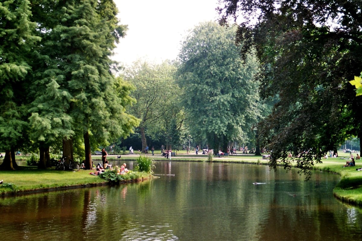 Pond, trees and walking paths in Vondelpark Amsterdam