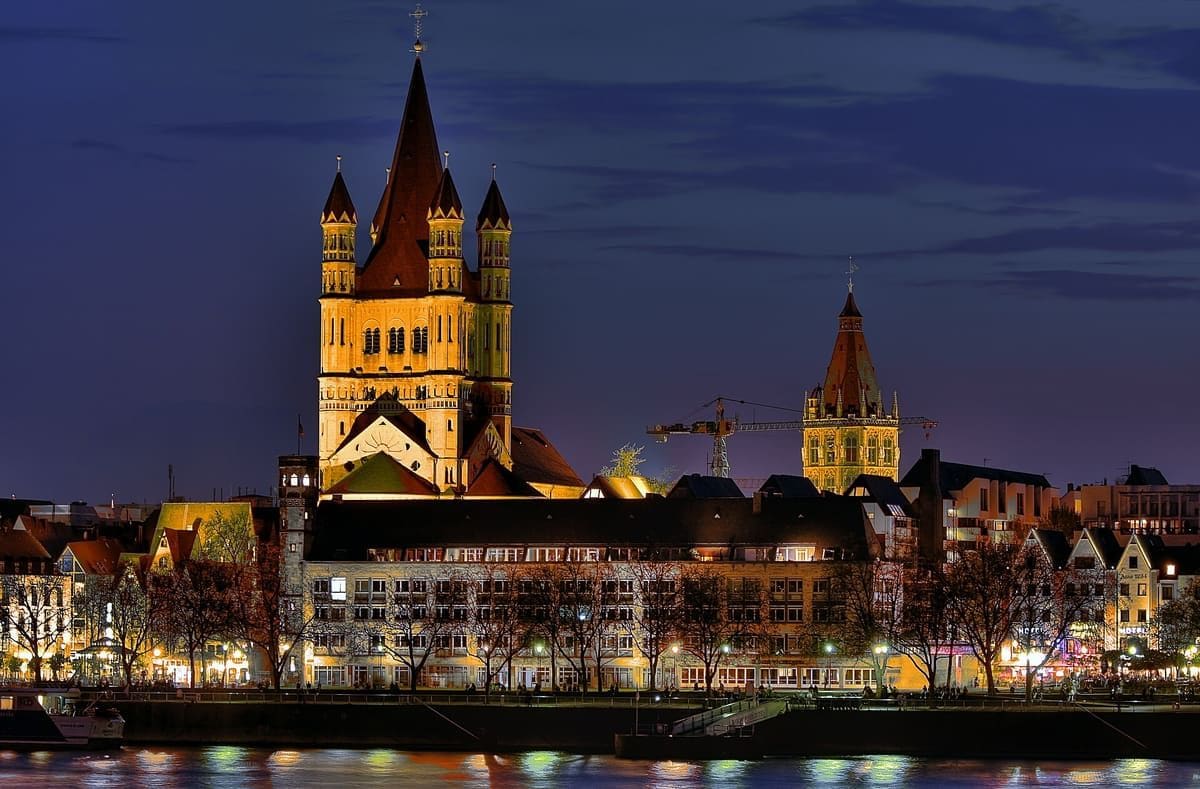 Cologne Old Town and Great St Martin Church beside the Rhine at dusk