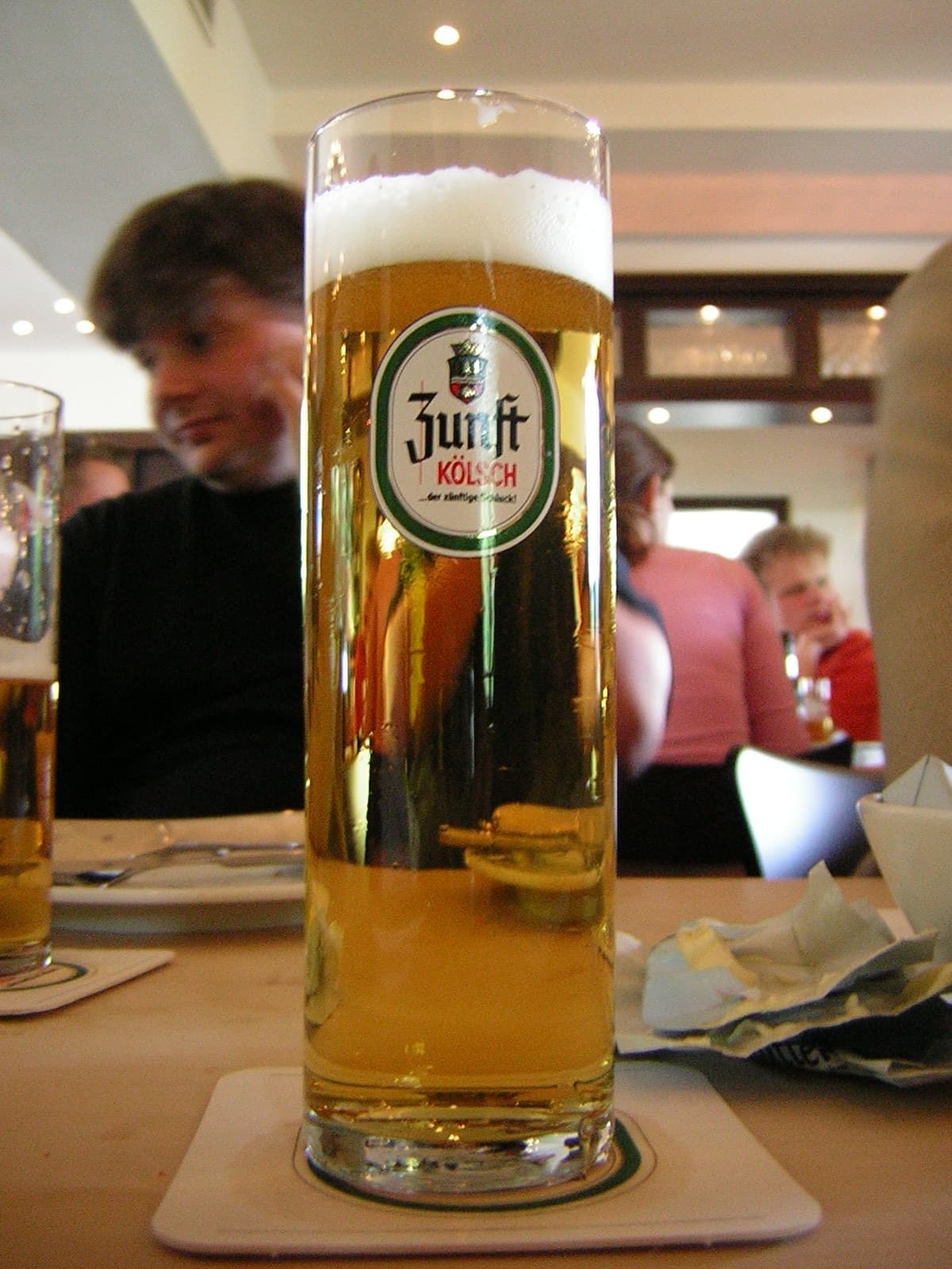 A narrow glass of Kölsch beer
