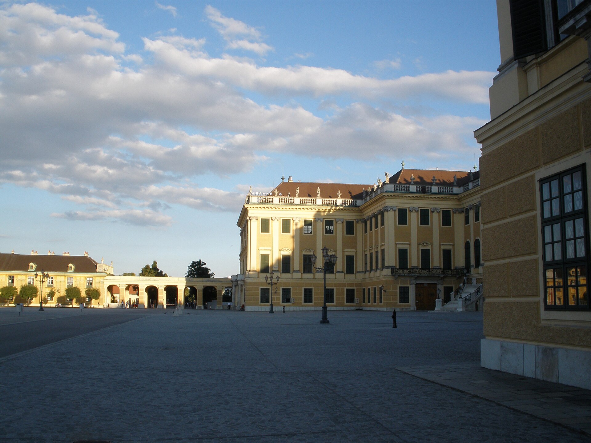 Yellow facade of Schönbrunn Palace seen across the main courtyard in Vienna