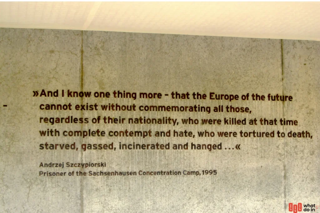 A powerful quote displayed on a concrete wall at the Sachsenhausen Concentration Camp memorial. The text, by former prisoner Andrzej Szczypiorski, emphasizes the necessity of remembering all victims of the Holocaust—regardless of nationality—who suffered and died through acts of hate, torture, starvation, gassing, and execution. The quote highlights the importance of remembrance in shaping a humane future for Europe.